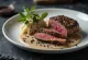 Emu fillet with pepper sauce served with vegetables.