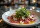 Horse meat carpaccio served with arugula, Parmesan, and capers.