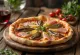 Capricciosa pizza með ansjósum borin fram